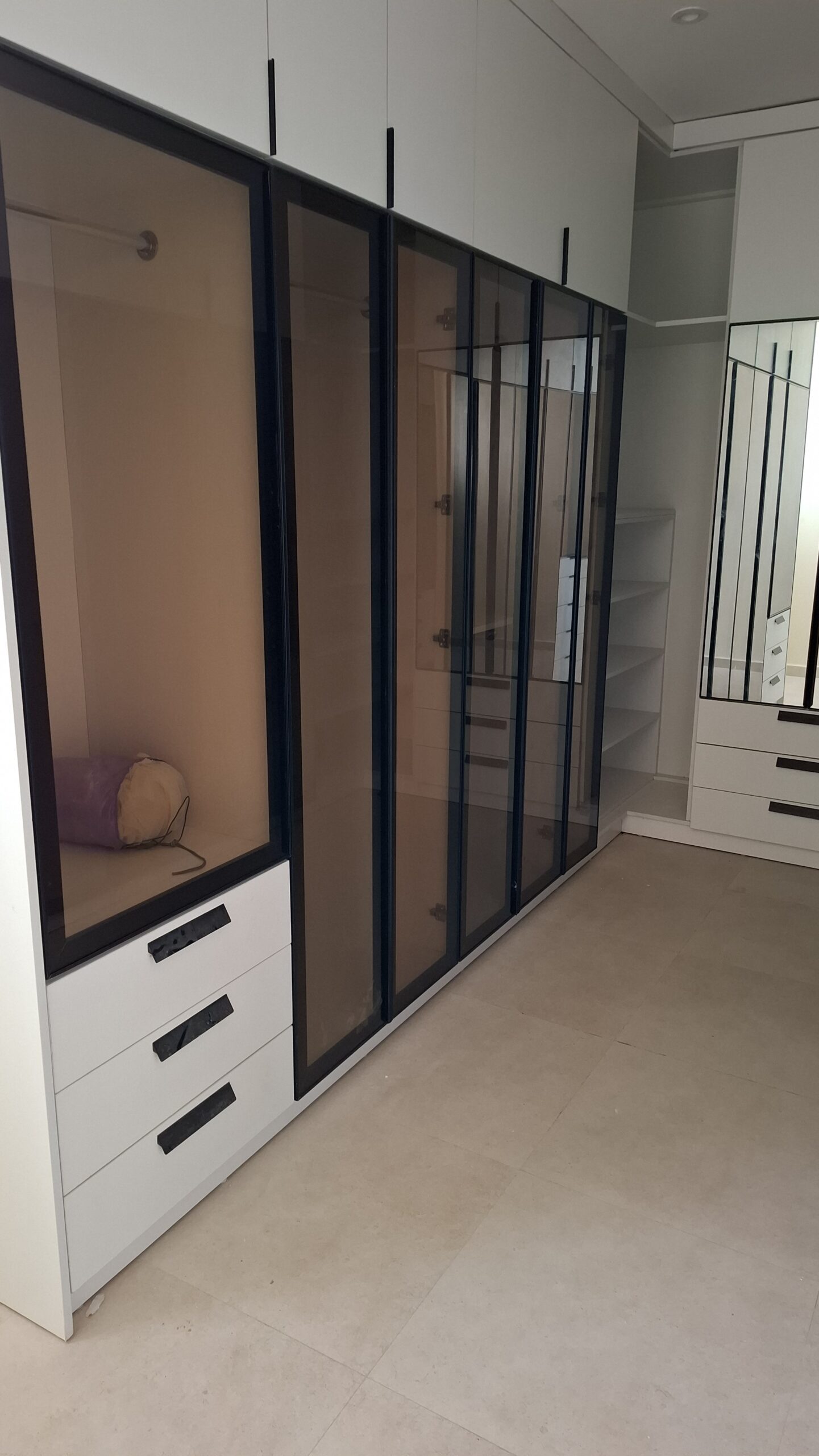 Bespoke modern wardrobe installation with modular storage by Joanswood Creation in Magodo, Lagos.